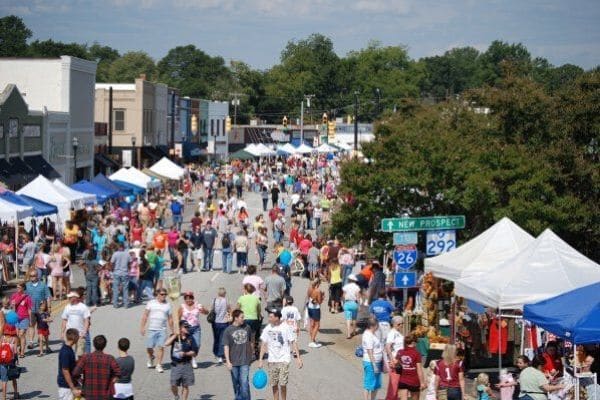 Festival in Inman, SC with people walking from booth to booth.